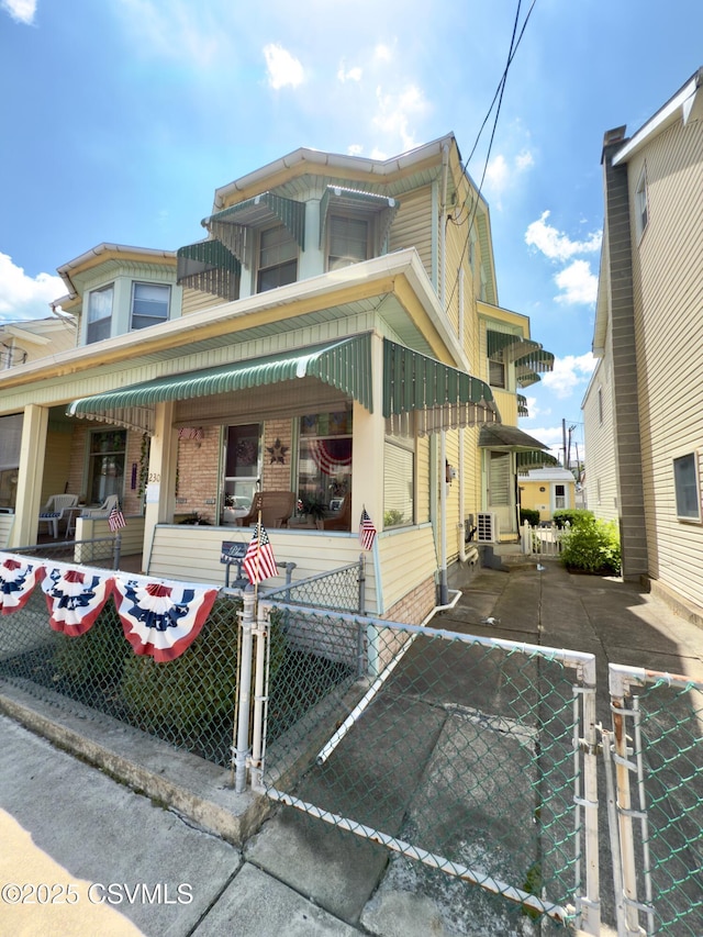 230 S 6th St, Shamokin, PA 17872 - view of front of house featuring a gate, a fenced front yard, and covered porch