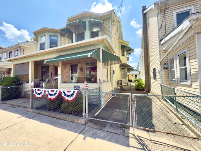 230 S 6th St, Shamokin, PA 17872 - view of front of home with a gate, a fenced front yard, and a porch