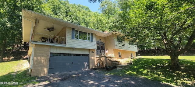 97 Maplewood Rd, Berwick, PA 18603 - bi-level home with brick siding, a balcony, a garage, a front lawn, and driveway