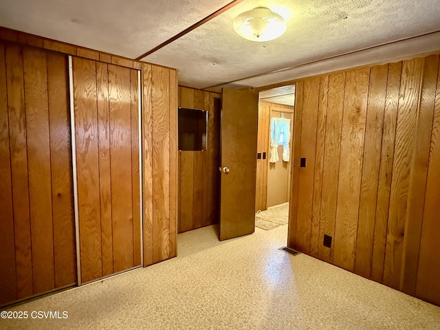 25 Wolfe Rd, Nescopeck, PA 18635 - unfurnished bedroom featuring wooden walls and a textured ceiling