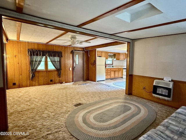 25 Wolfe Rd, Nescopeck, PA 18635 - unfurnished living room featuring heating unit, wooden walls, light colored carpet, wainscoting, and ceiling fan