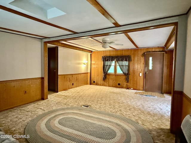 25 Wolfe Rd, Nescopeck, PA 18635 - empty room with wooden walls, carpet floors, wainscoting, and a ceiling fan