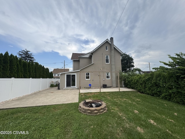 1715 Spring Garden Ave, Berwick, PA 18603 - back of property featuring a patio, an outdoor fire pit, a chimney, and concrete driveway