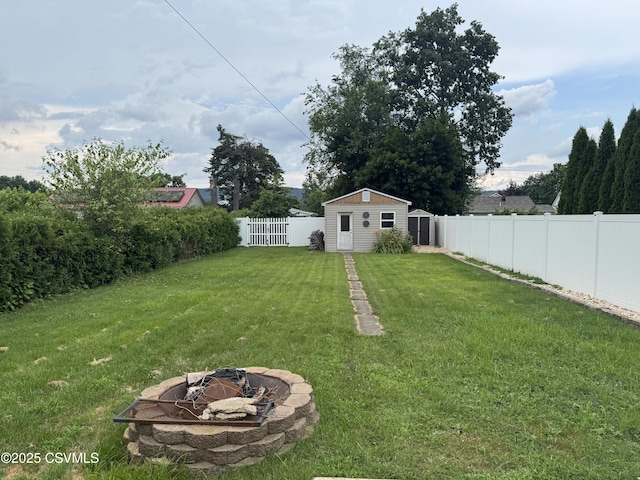 1715 Spring Garden Ave, Berwick, PA 18603 - fenced backyard with an outdoor fire pit and a storage unit