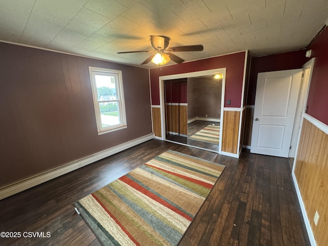 1715 Spring Garden Ave, Berwick, PA 18603 - unfurnished bedroom with wood-type flooring, a baseboard radiator, wainscoting, wood walls, and a closet