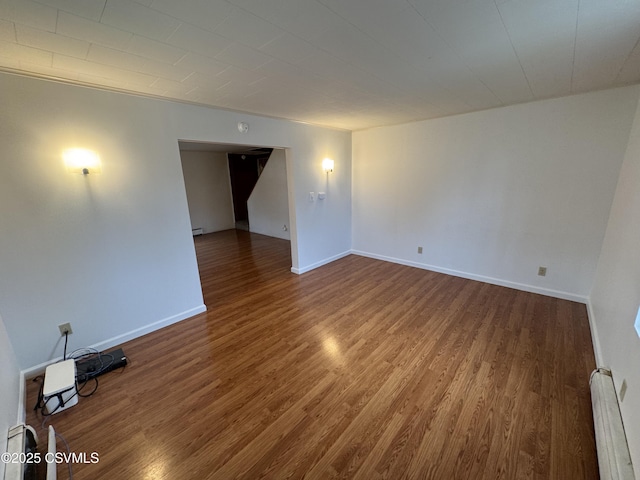 1715 Spring Garden Ave, Berwick, PA 18603 - empty room with wood finished floors and a baseboard radiator