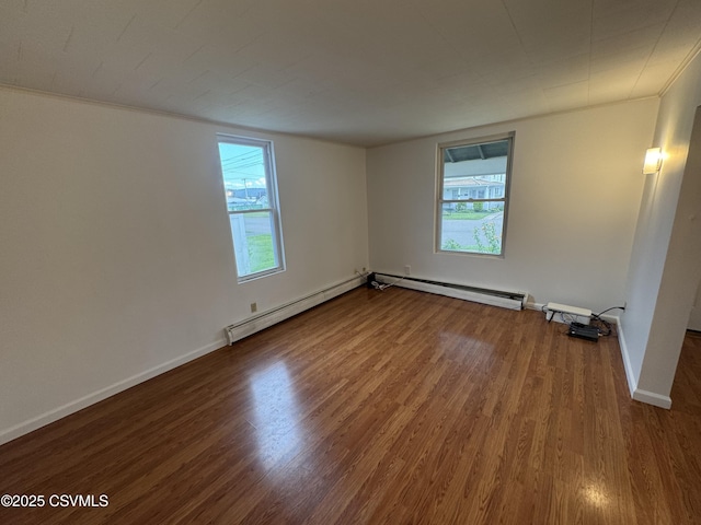 1715 Spring Garden Ave, Berwick, PA 18603 - empty room featuring a baseboard heating unit, healthy amount of natural light, and wood finished floors