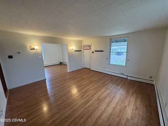 1715 Spring Garden Ave, Berwick, PA 18603 - unfurnished room featuring baseboard heating and wood finished floors