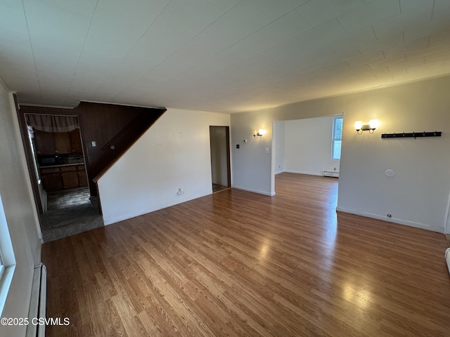 1715 Spring Garden Ave, Berwick, PA 18603 - unfurnished living room with wood finished floors, a baseboard radiator, and a baseboard heating unit