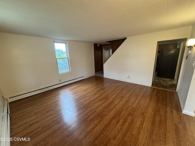 1715 Spring Garden Ave, Berwick, PA 18603 - empty room with baseboard heating, wood finished floors, and stairway