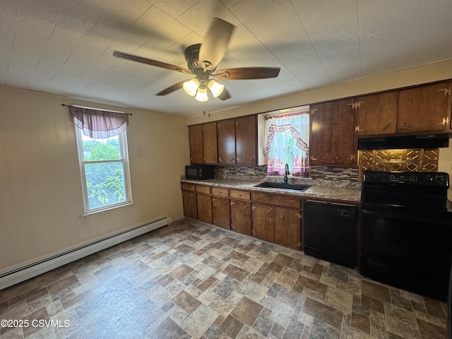 1715 Spring Garden Ave, Berwick, PA 18603 - kitchen featuring black appliances, under cabinet range hood, a baseboard heating unit, and healthy amount of natural light