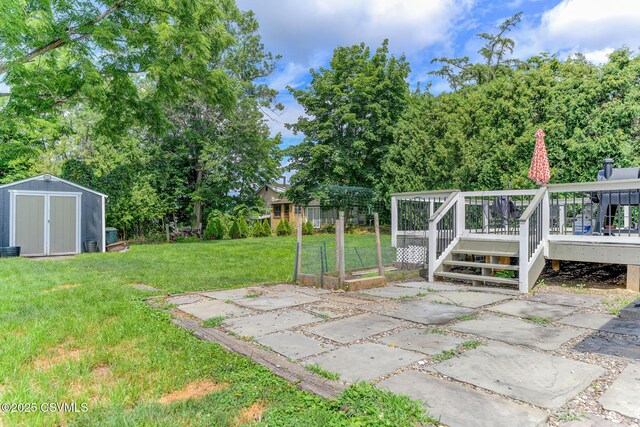 745 Liberty St, Danville, PA 17821 - view of green lawn featuring a shed, a deck, a vegetable garden, and a patio area