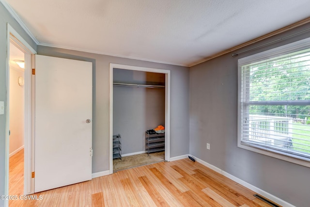 745 Liberty St, Danville, PA 17821 - unfurnished bedroom with light wood-style flooring, ornamental molding, and a closet