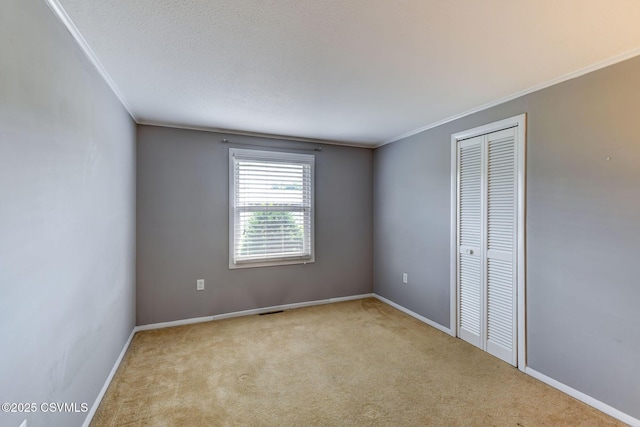 745 Liberty St, Danville, PA 17821 - unfurnished bedroom featuring crown molding, carpet floors, and a closet