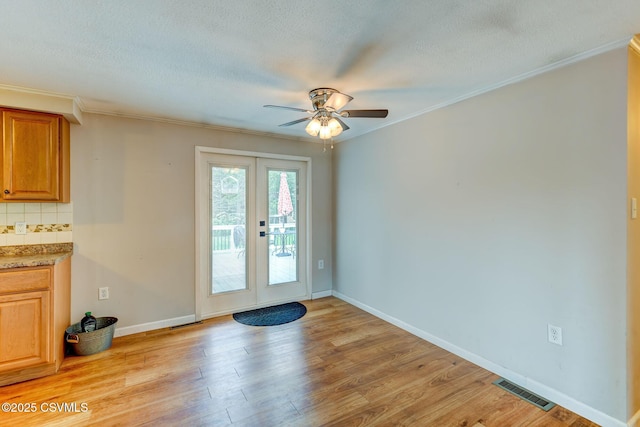 745 Liberty St, Danville, PA 17821 - doorway to outside featuring ceiling fan, french doors, light wood-style floors, crown molding, and a textured ceiling