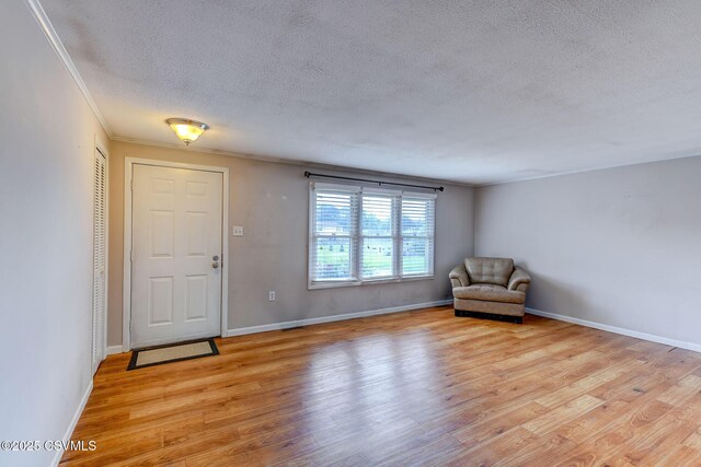 745 Liberty St, Danville, PA 17821 - entryway featuring a textured ceiling, light wood-type flooring, and ornamental molding