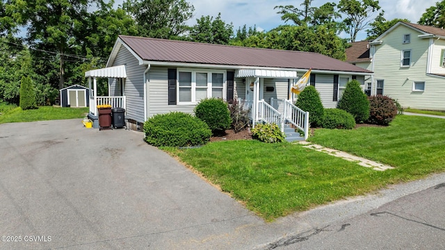 745 Liberty St, Danville, PA 17821 - view of front facade with a storage shed, a metal roof, and a front lawn