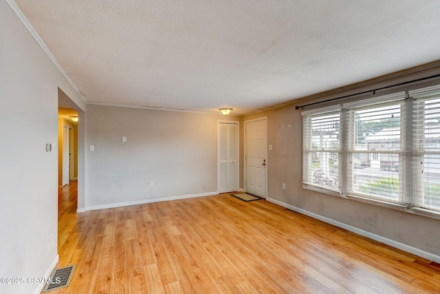 745 Liberty St, Danville, PA 17821 - unfurnished room featuring light wood-style flooring, crown molding, and a textured ceiling