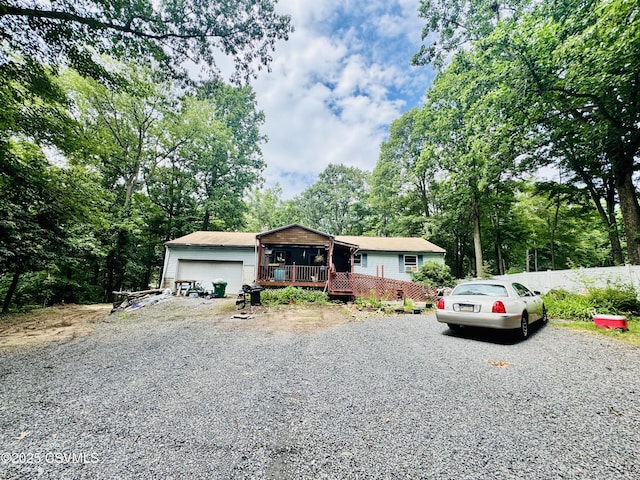 249 E Haas Manor Rd, Sunbury, PA 17801 - ranch-style house with gravel driveway, a deck, and an attached garage