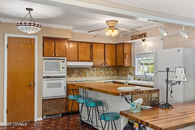 725 Avenue Ave E, Danville, PA 17821 - kitchen with white appliances, under cabinet range hood, wooden counters, brown cabinetry, and backsplash