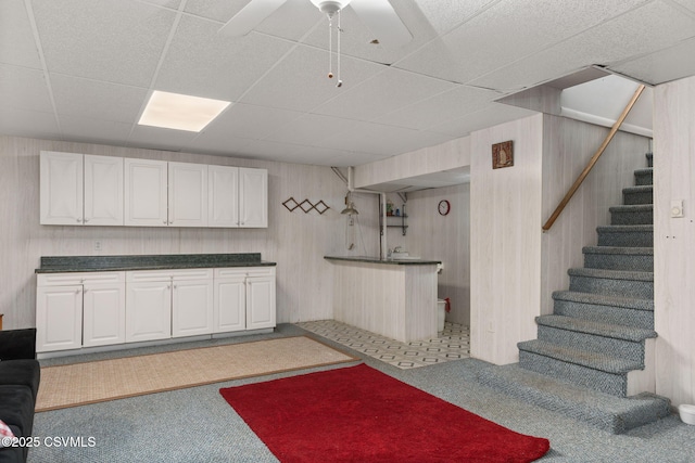 725 Avenue Ave E, Danville, PA 17821 - kitchen featuring carpet flooring, a drop ceiling, ceiling fan, white cabinetry, and dark countertops