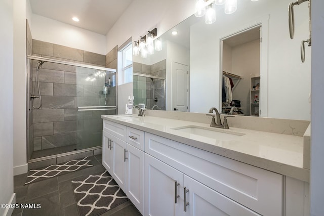 11512 Cepheus Rd, Bellemont, AZ 86015 - full bathroom with a walk in closet, a sink, a shower stall, and double vanity