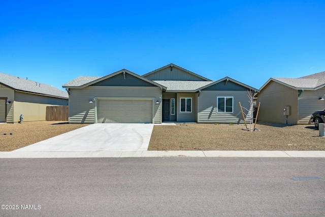 11512 Cepheus Rd, Bellemont, AZ 86015 - ranch-style house featuring board and batten siding, an attached garage, and concrete driveway