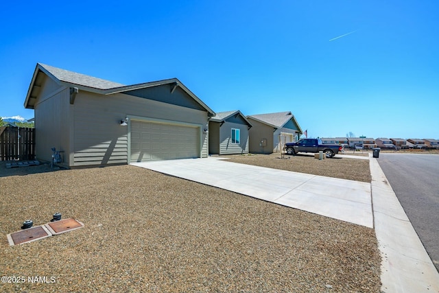 11512 Cepheus Rd, Bellemont, AZ 86015 - view of front of home with an attached garage, concrete driveway, and fence