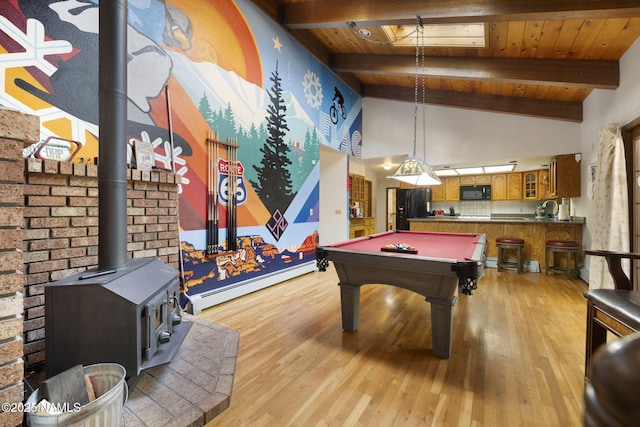 3120 W Tami Ln, Flagstaff, AZ 86001 - game room with a baseboard heating unit, wood ceiling, a wood stove, beamed ceiling, and light wood finished floors