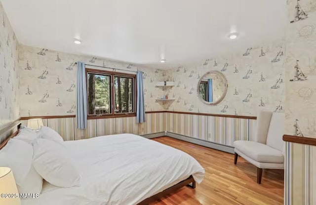 3120 W Tami Ln, Flagstaff, AZ 86001 - bedroom with wallpapered walls, wood finished floors, and a baseboard radiator