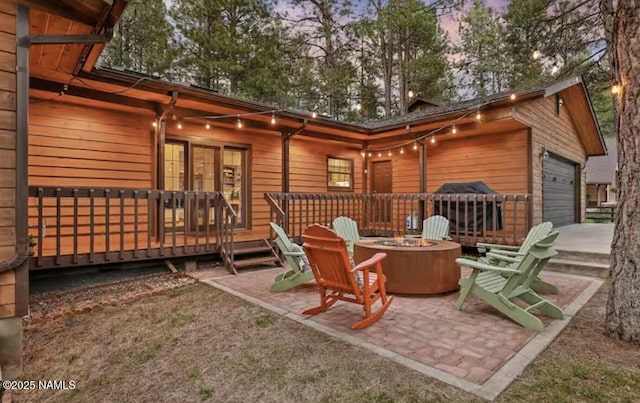 3120 W Tami Ln, Flagstaff, AZ 86001 - back of property at dusk featuring a fire pit and a wooden deck