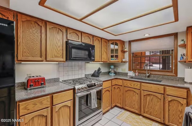 3120 W Tami Ln, Flagstaff, AZ 86001 - kitchen featuring black appliances, a sink, brown cabinets, light tile patterned floors, and glass insert cabinets