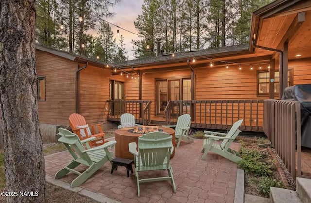 3120 W Tami Ln, Flagstaff, AZ 86001 - patio terrace at dusk featuring an outdoor fire pit and a wooden deck