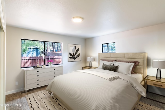 bedroom featuring light colored carpet and multiple windows