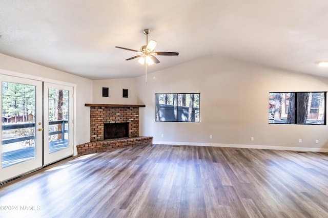 unfurnished living room with vaulted ceiling, ceiling fan, hardwood / wood-style floors, and a fireplace