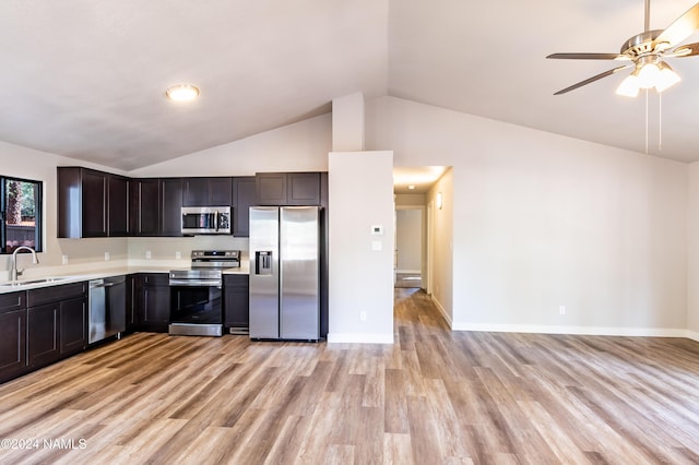 kitchen with sink, appliances with stainless steel finishes, light hardwood / wood-style flooring, and dark brown cabinets