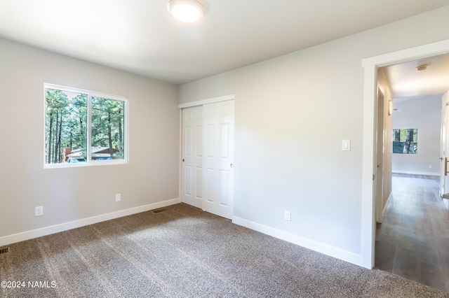 unfurnished bedroom with a closet and carpet