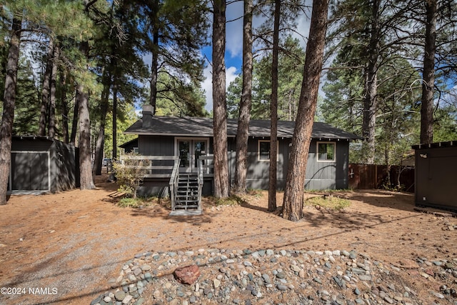 view of front of home featuring a storage unit