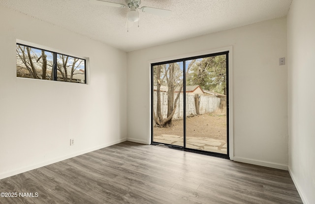 spare room featuring hardwood / wood-style flooring, a textured ceiling, and ceiling fan