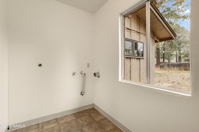 laundry area featuring hookup for a washing machine, hookup for an electric dryer, and tile patterned flooring