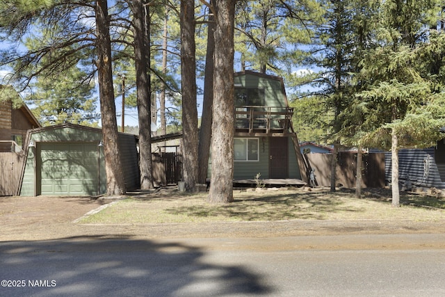 937 Osage, Flagstaff, AZ 86005 - a-frame home with fence, an outbuilding, a detached garage, and dirt driveway