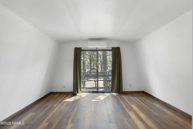 937 Osage, Flagstaff, AZ 86005 - empty room featuring vaulted ceiling, baseboards, wood finished floors, and a wall mounted air conditioner