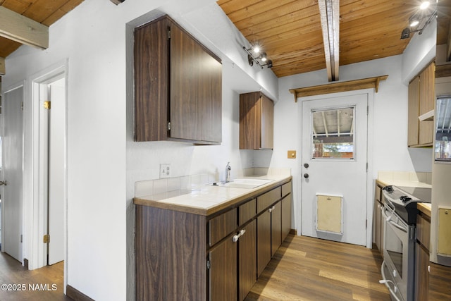937 Osage, Flagstaff, AZ 86005 - kitchen with stainless steel range with electric stovetop, wooden ceiling, wood finished floors, a sink, and beamed ceiling