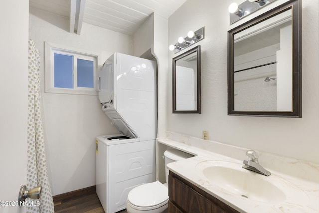 937 Osage, Flagstaff, AZ 86005 - bathroom with stacked washer and clothes dryer, toilet, vanity, wood finished floors, and beamed ceiling
