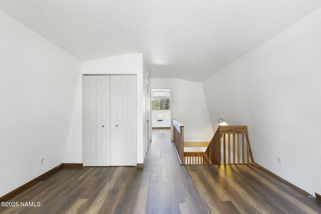 937 Osage, Flagstaff, AZ 86005 - unfurnished bedroom with vaulted ceiling, dark wood finished floors, a closet, and baseboards