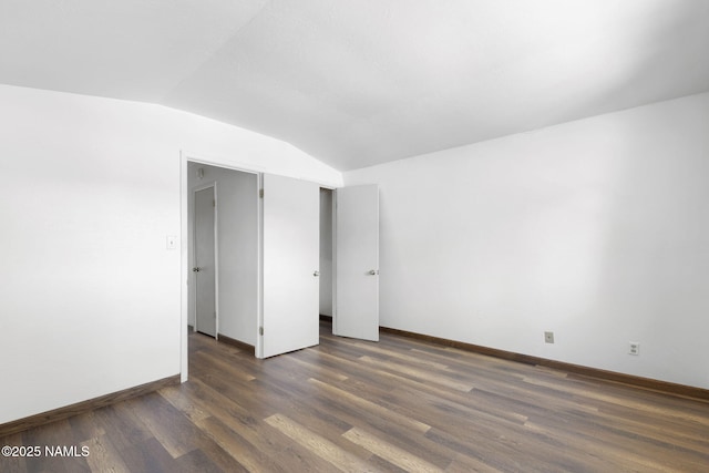 937 Osage, Flagstaff, AZ 86005 - unfurnished room featuring vaulted ceiling, dark wood-style flooring, and baseboards