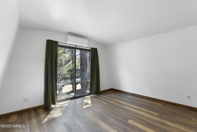 937 Osage, Flagstaff, AZ 86005 - empty room with a wall unit AC, lofted ceiling, wood finished floors, and baseboards