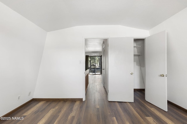 937 Osage, Flagstaff, AZ 86005 - unfurnished bedroom featuring wood finished floors, vaulted ceiling, and baseboards