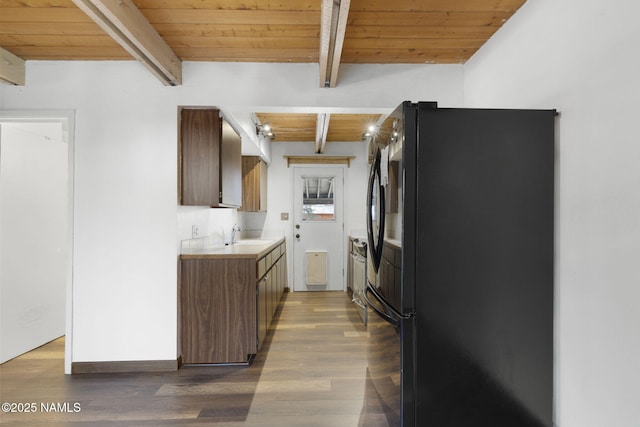 937 Osage, Flagstaff, AZ 86005 - kitchen featuring freestanding refrigerator, beamed ceiling, wood ceiling, light countertops, and a sink
