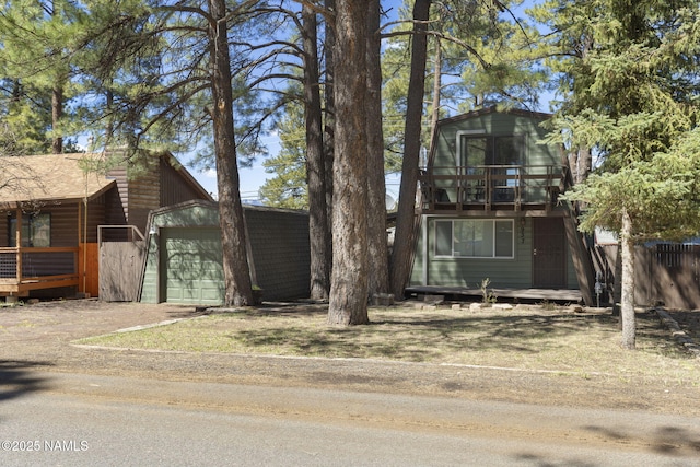937 Osage, Flagstaff, AZ 86005 - a-frame style home featuring an outbuilding, fence, a balcony, and dirt driveway